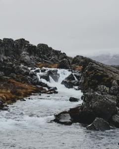river flowing between rocky formations on hill